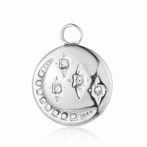 Detailed macro view of silver stainless steel celestial pendant with crescent and stars