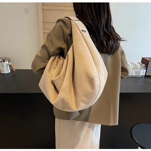 Modern beige matte suede tote bag shown on model for a minimalist daily commuting style