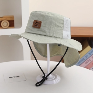 Detail of light green sun hat with mesh vents, neck flap and leather Lucky patch