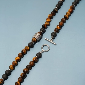 Detail of 8mm tiger eye and lava stone beaded necklace with a silver T-bar toggle clasp