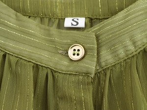Macro view of green pleated chiffon fabric with gold stripes and size S button detail