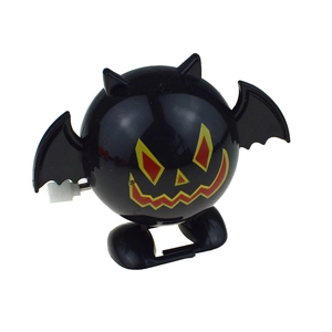 Detail of mechanical wind-up mechanism on black bat toy with pumpkin face for Halloween
