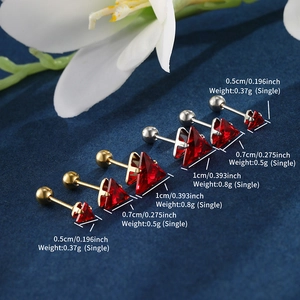 Macro detail of triangle red zircon screw-back earrings in gold and silver plating