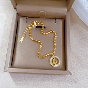 Titanium steel gold beaded bracelet featuring a sparkling celestial moon and star charm
