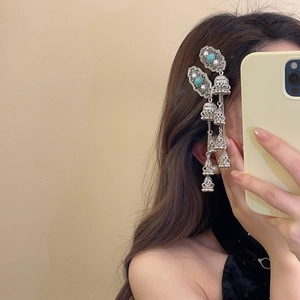 Vintage silver bohemian tassel earrings with turquoise and pearls worn by a model