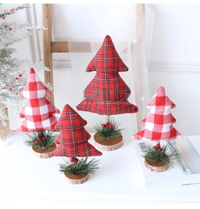 Detailed view of mini fabric Christmas trees with plaid patterns and wooden bases