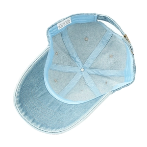 Washed denim baseball cap featuring six-panel interior structure and metal buckle