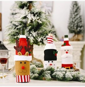 Three festive Christmas wine bottle covers featuring Santa, reindeer, and snowman designs