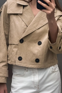 Detail of khaki short double-breasted hooded windbreaker jacket with black round buttons
