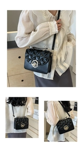Close-up of black quilted crossbody bag featuring a golden circular clasp and matte finish