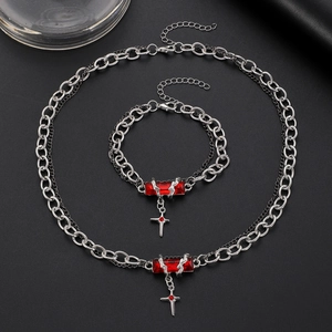 Gothic silver necklace and bracelet set featuring a red gemstone and cross pendant