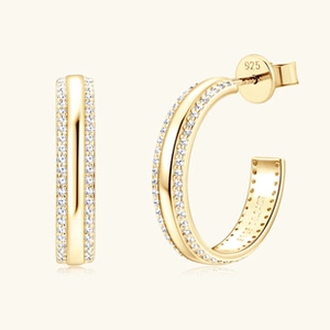 Detail of 925 sterling silver gold-plated C-shaped earrings with micro-set zircons