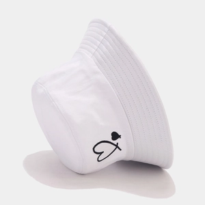 Detail of white cotton bucket hat featuring black heart embroidery and stitched brim