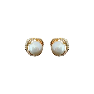 Elegant pearl stud earrings with hollow gold zircon halo on white background