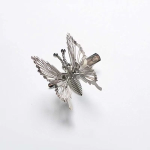 Elegant silver butterfly hair clip with intricate hollow wings and metallic texture