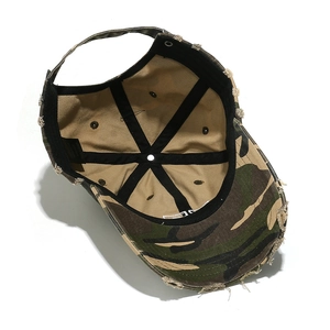 Detailed interior of distressed camo baseball cap with khaki canvas lining and hardware