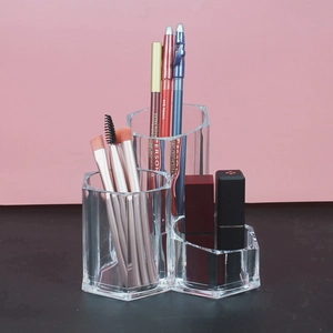 Close-up of hexagonal clear acrylic lipstick organizer with multiple compartments for cosmetics