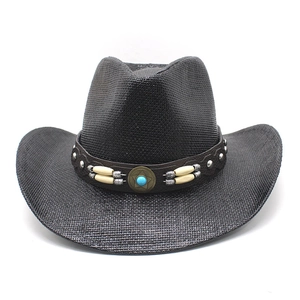 Detail of black straw cowboy hat featuring turquoise star emblem and leather band
