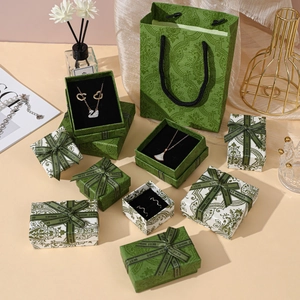 Detail of vintage green floral jewelry gift boxes and matching paper shopping bags