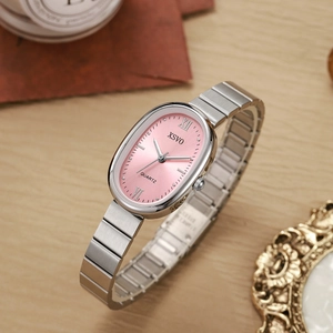 Detailed macro view of an oval pink dial watch with silver bamboo steel strap