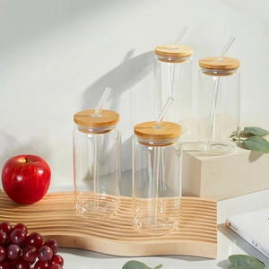 Detailed set of four can-shaped glass cups with bamboo lids and curved glass straws