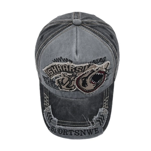 Detailed macro view of retro washed grey baseball cap with shark embroidery and distressed patches