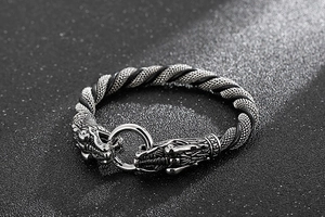 Macro view of vintage double dragon head clasp and woven stainless steel chain