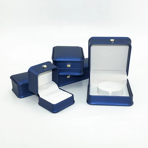 Detail of navy blue crown jewelry boxes with white interior for rings and necklaces