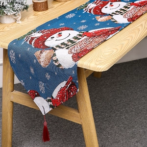 Navy blue knitted Christmas table runner with snowman patterns and red tassels decoration
