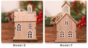Detail of wooden Christmas house models E and F with snowy roofs and festive rustic decor