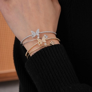 Close-up of double-layer butterfly and clover open bangles with zircon inlay