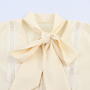 Elegant beige chiffon blouse with delicate lace splicing and a stylish self-tie bow neck