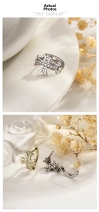 Detail of zircon-encrusted cross earrings showing polished gold and silver finishes
