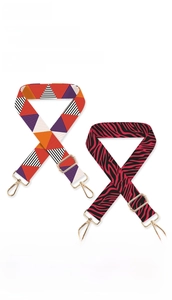 Detail showing adjustable polyester straps with geometric and leopard patterns and gold clasps