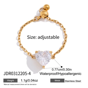 Detail of adjustable stainless steel ring with heart zircon and sliding chain design