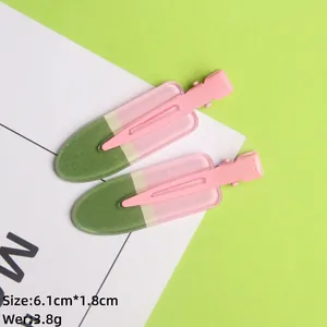 Detail of popsicle hair clip measuring 6.1cm by 1.8cm in pink and green colors
