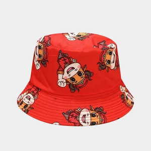 Detail of red bucket hat with festive cartoon ox pattern and traditional Chinese embroidery