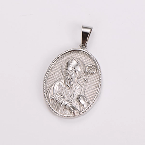 Detail showing an oval stainless steel religious saint pendant with embossed figure