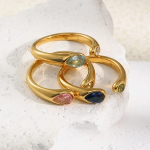 Three 18K gold-plated snake head rings with blue and pink teardrop zircon stones on white rock