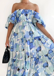 Detail of teal abstract dot print on an off-shoulder tiered dress with elastic waist