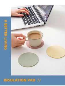 Detailed view of Morandi-colored silicone insulation pads on a modern minimalist desk