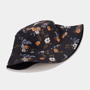 Detailed close-up of a foldable reversible sun hat featuring a vibrant floral pattern on twill