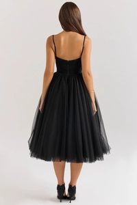 Elegant back view of black backless evening dress with layered mesh tulle skirt