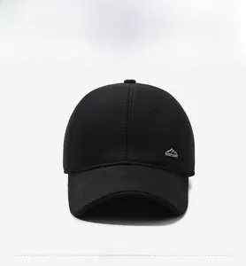 Close-up of black woolen baseball cap with textured fabric and mini metal mountain logo