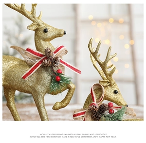 Detail of golden glitter reindeer figures with pine cones and berries on a warm festive background