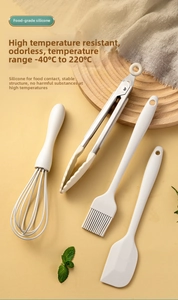 Macro view of food-grade silicone baking set with stainless steel handles and oil brush