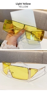 Dettaglio di occhiali da sole Y2K rettangolari con lenti giallo chiaro e aste in metallo