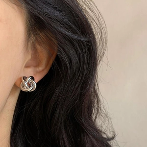 Elegant silver twisted knot stud earrings for women with minimalist metallic mirror finish