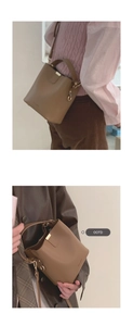 Detail showing brown pebble leather bucket bag with gold hardware and adjustable strap
