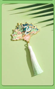 Detail of fan-shaped enamel Hangzhou West Lake magnet with Leifeng Pagoda and white tassels